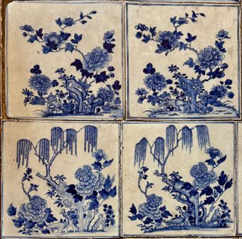 Four blue-and-white Chinese floral porcelain tiles laid in a grid, part of the hand-painted tile floor at Paradesi Synagogue.