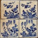 Four blue-and-white Chinese floral porcelain tiles laid in a grid, part of the hand-painted tile floor at Paradesi Synagogue.