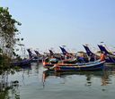 Moored fishing boats with colorful painted bows