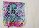 A woven portrait at St. Andrew’s Parish Hall made from strips of pink and teal sanitary-product wrappers.