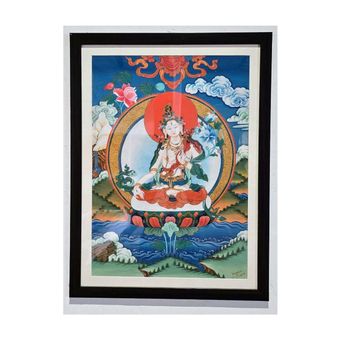 A framed thangka painting of White Tara seated on a lotus, a red halo behind her, set against blue sky, clouds and green hills.