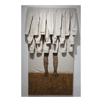 A wall work: a row of empty white shirts hanging above a painted field of ripe wheat, from which a single pair of legs in thick woollen socks rises without a body.