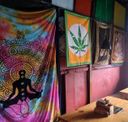 Restaurant interior wall hung with tie-dye chakra tapestry and deity cloth prints.